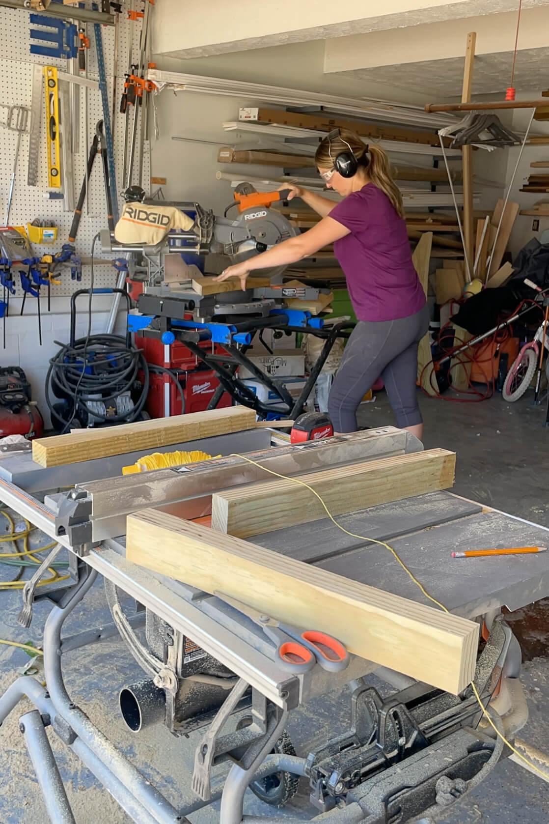 Using a miter saw to cut wood for DIY mailbox makeover. 